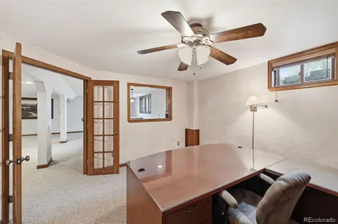 a view of a livingroom with furniture and a ceiling fan