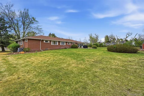 a view of a house with a yard and potted plants