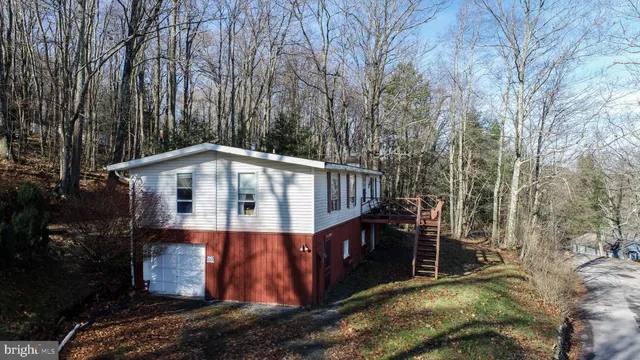 a view of a small house with trees in the background