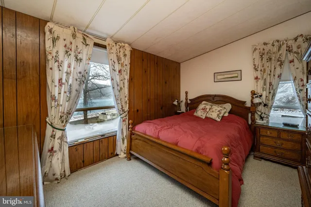 a bedroom with a bed and a lamp