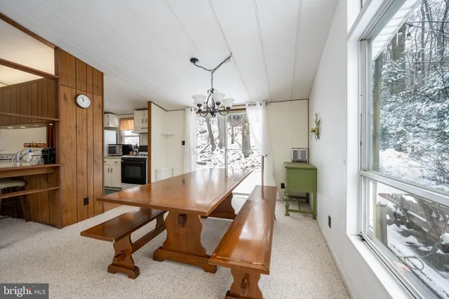 a living room with furniture a flat screen tv and a large window