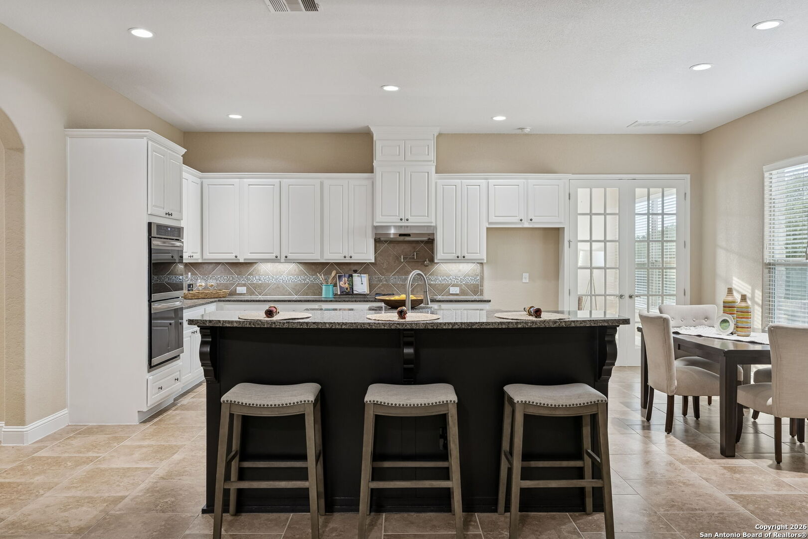 2194 Ranch Loop Drive New Braunfels, TX 78132 - Photo 18 of 52 a kitchen with a sink and chairs