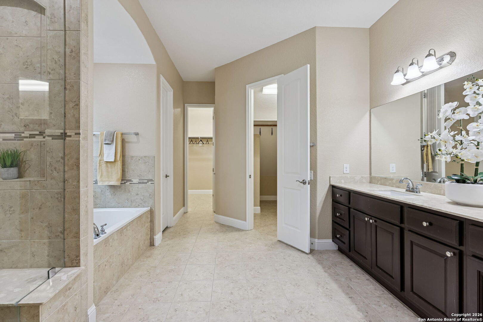 2194 Ranch Loop Drive New Braunfels, TX 78132 - Photo 22 of 52 a bathroom with a double vanity sink a large mirror and a shower