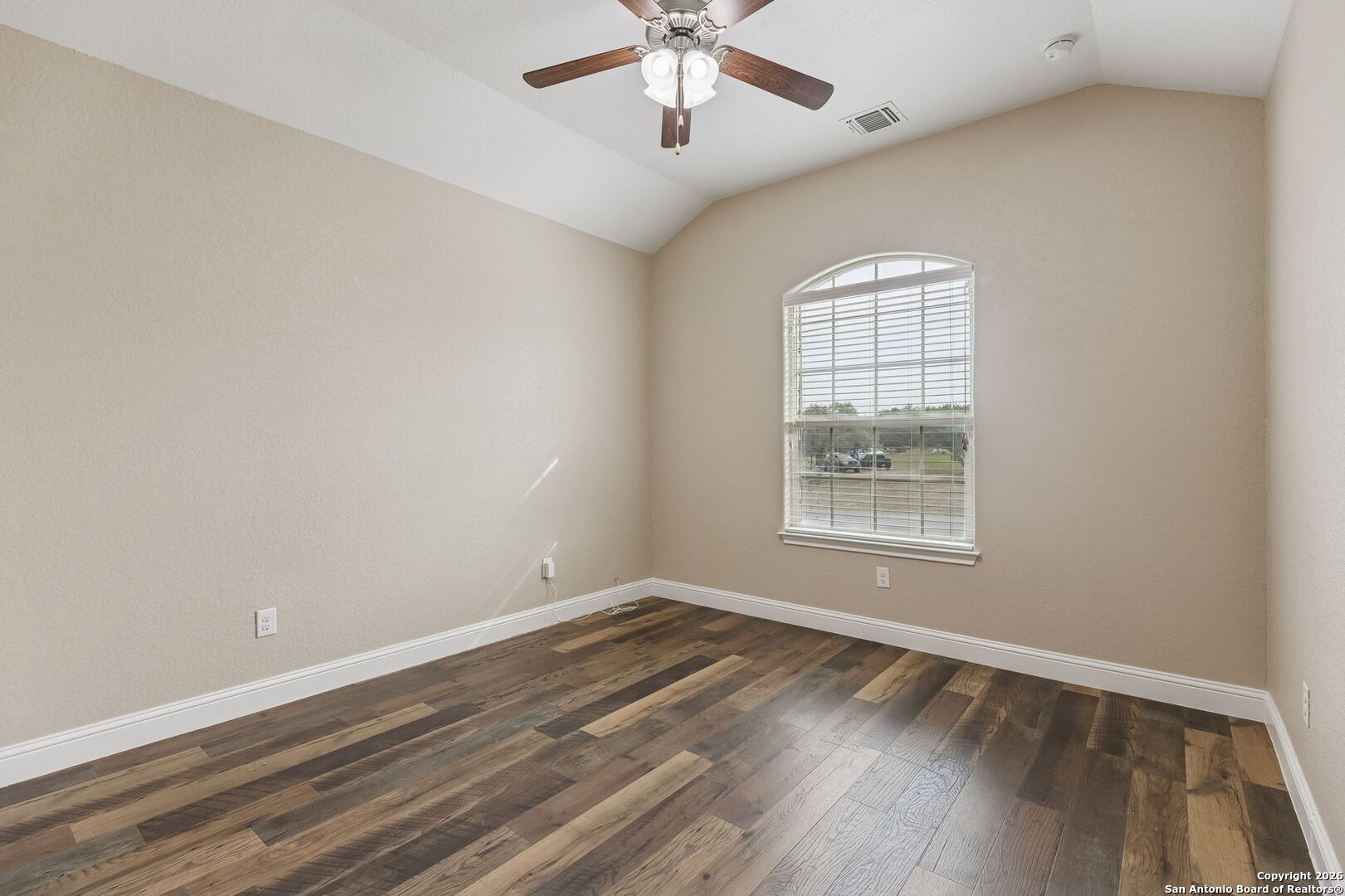 2194 Ranch Loop Drive New Braunfels, TX 78132 - Photo 29 of 52 an empty room with wooden floor chandelier fan and windows