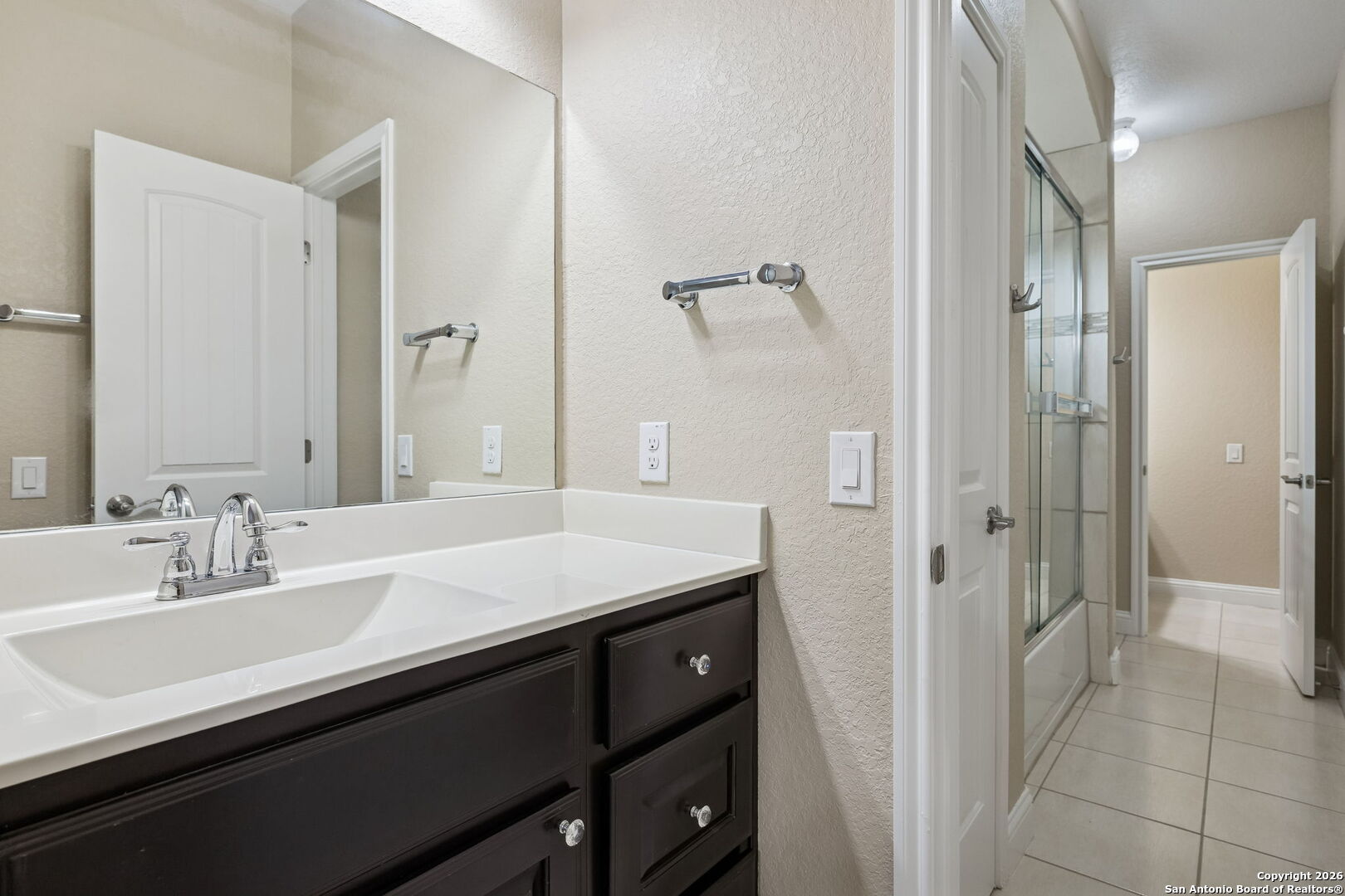 2194 Ranch Loop Drive New Braunfels, TX 78132 - Photo 31 of 52 a bathroom with a sink a mirror and a shower