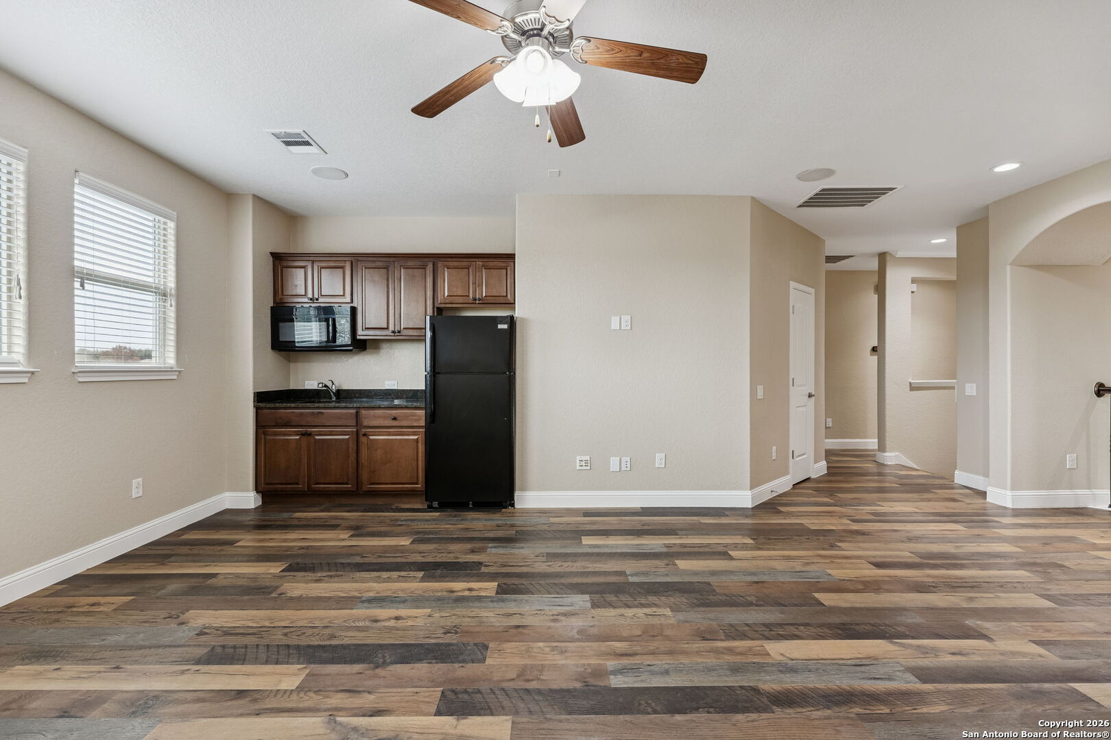 2194 Ranch Loop Drive New Braunfels, TX 78132 - Photo 40 of 52 a view of kitchen and empty room with wooden floor fan