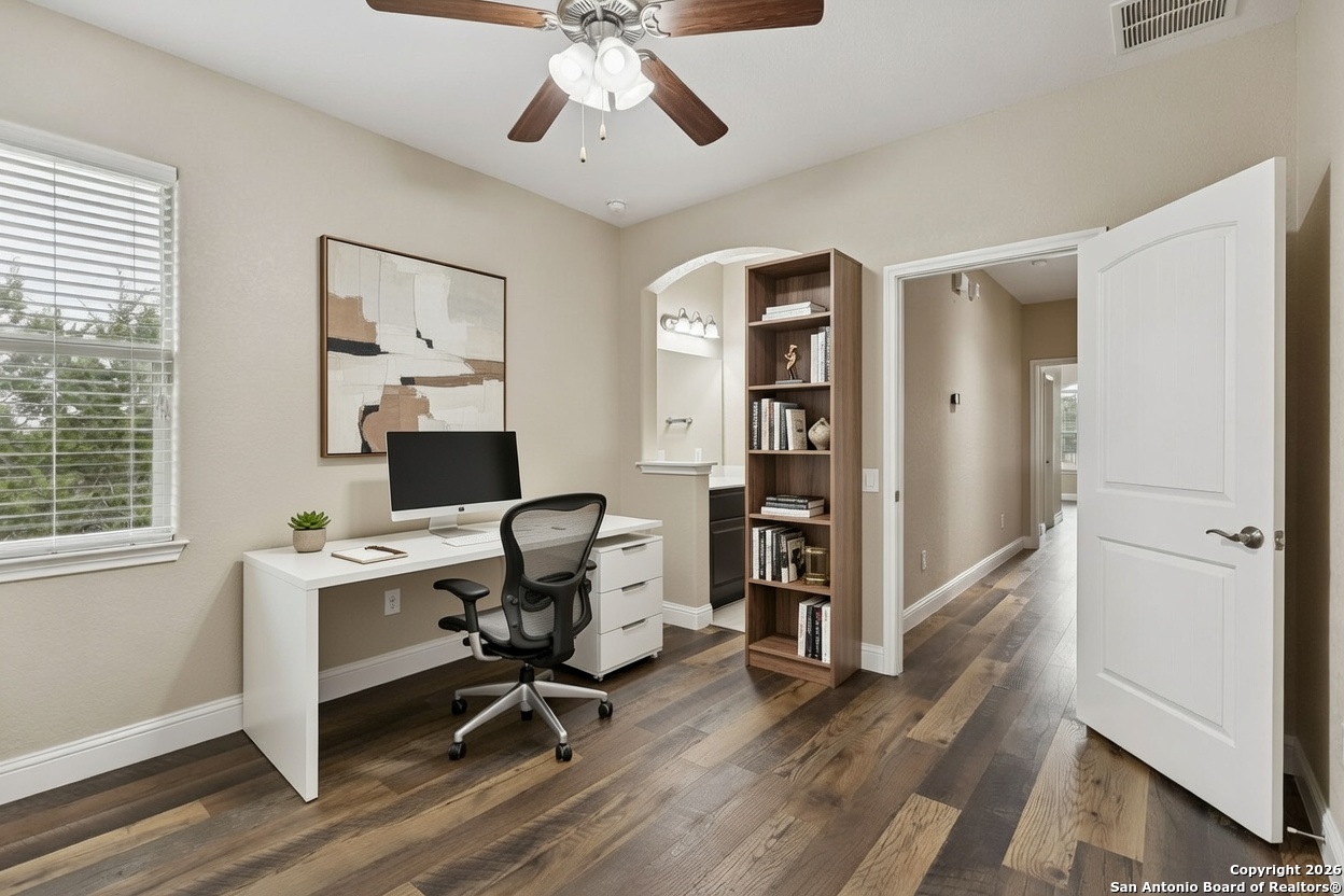 2194 Ranch Loop Drive New Braunfels, TX 78132 - Photo 42 of 52 a view of a workspace with wooden floor and a window