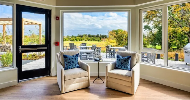 a living room with furniture and large windows