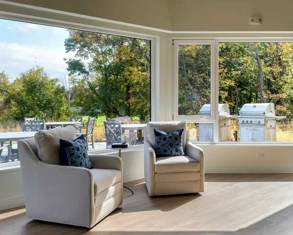 a living room with fireplace furniture and a large window