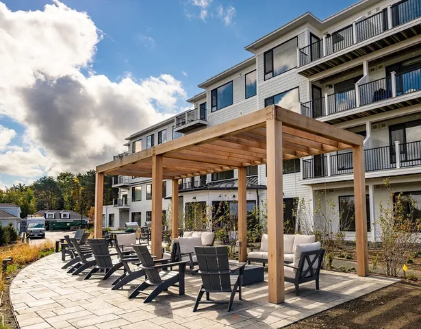 a view of a building with a table and chairs in patio