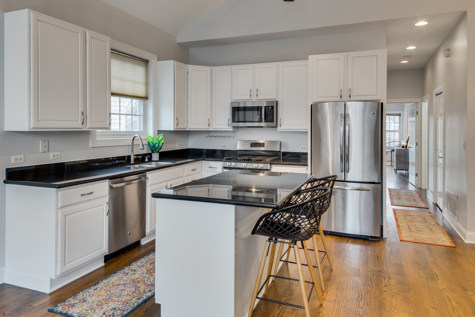 4146 North Lincoln Avenue, Unit 3 Chicago, IL 60618 - Photo 12 of 32 a kitchen with stainless steel appliances granite countertop a refrigerator a stove a sink and a microwave
