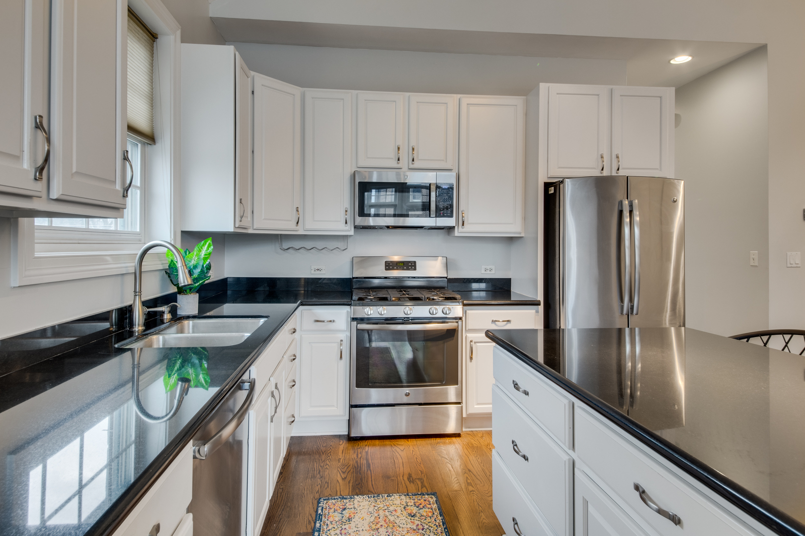 4146 North Lincoln Avenue, Unit 3 Chicago, IL 60618 - Photo 13 of 32 a kitchen with stainless steel appliances granite countertop a refrigerator a stove and a sink