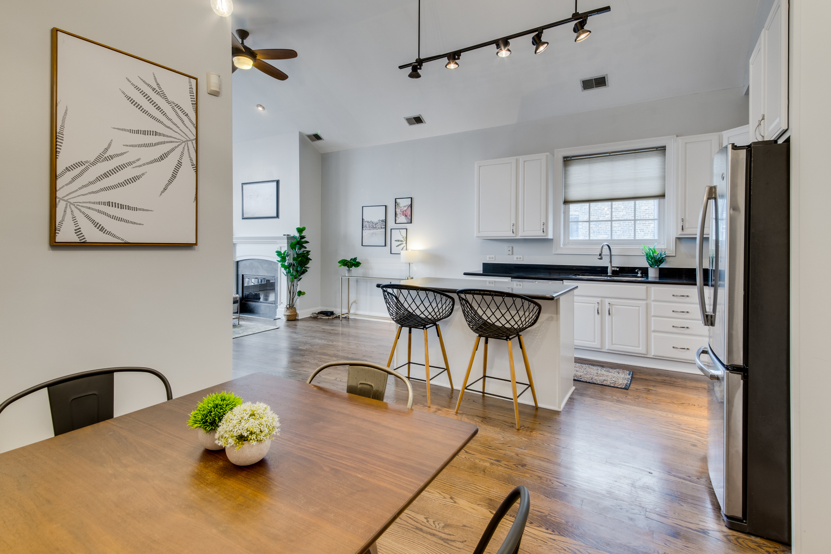 4146 North Lincoln Avenue, Unit 3 Chicago, IL 60618 - Photo 14 of 32 a kitchen with stainless steel appliances a dining table chairs and wooden floor