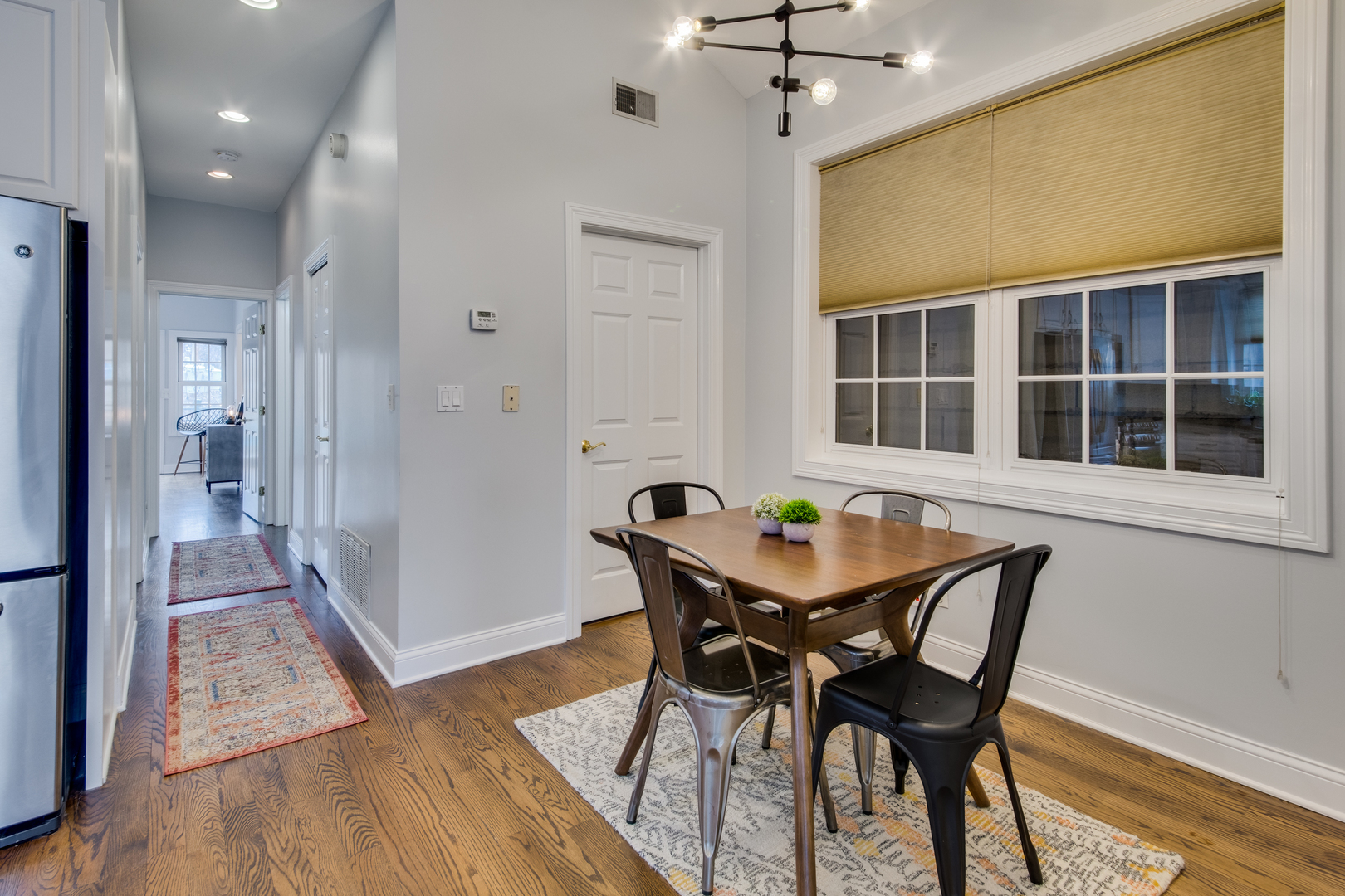 4146 North Lincoln Avenue, Unit 3 Chicago, IL 60618 - Photo 17 of 32 a view of a dining room with furniture and a chandelier