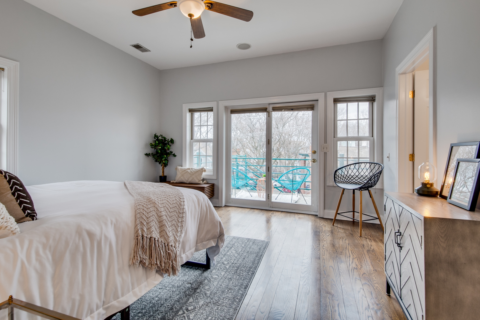 4146 North Lincoln Avenue, Unit 3 Chicago, IL 60618 - Photo 19 of 32 a bedroom with a bed and a large window with wooden floor