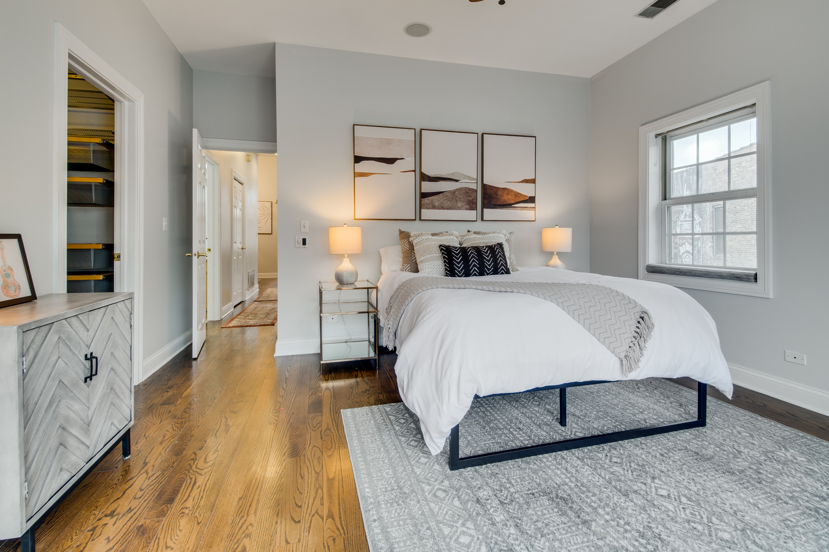 4146 North Lincoln Avenue, Unit 3 Chicago, IL 60618 - Photo 21 of 32 a bedroom with a bed and a large mirror