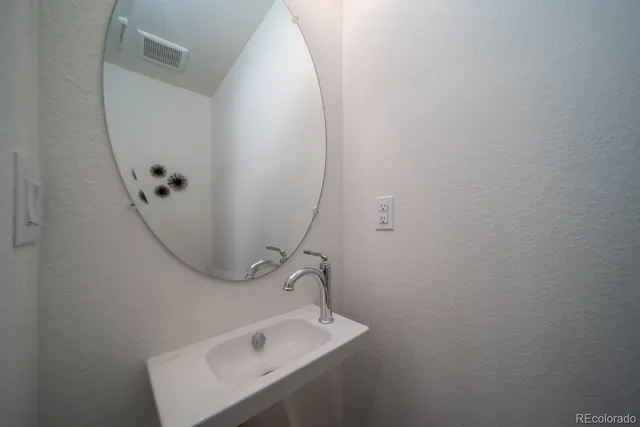 a bathroom with a sink and mirror