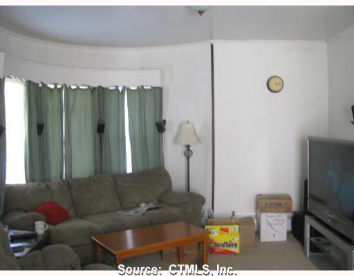 49 Revere Street Waterbury, CT 06708 - Photo 1 of 1 a living room with furniture and a flat screen tv