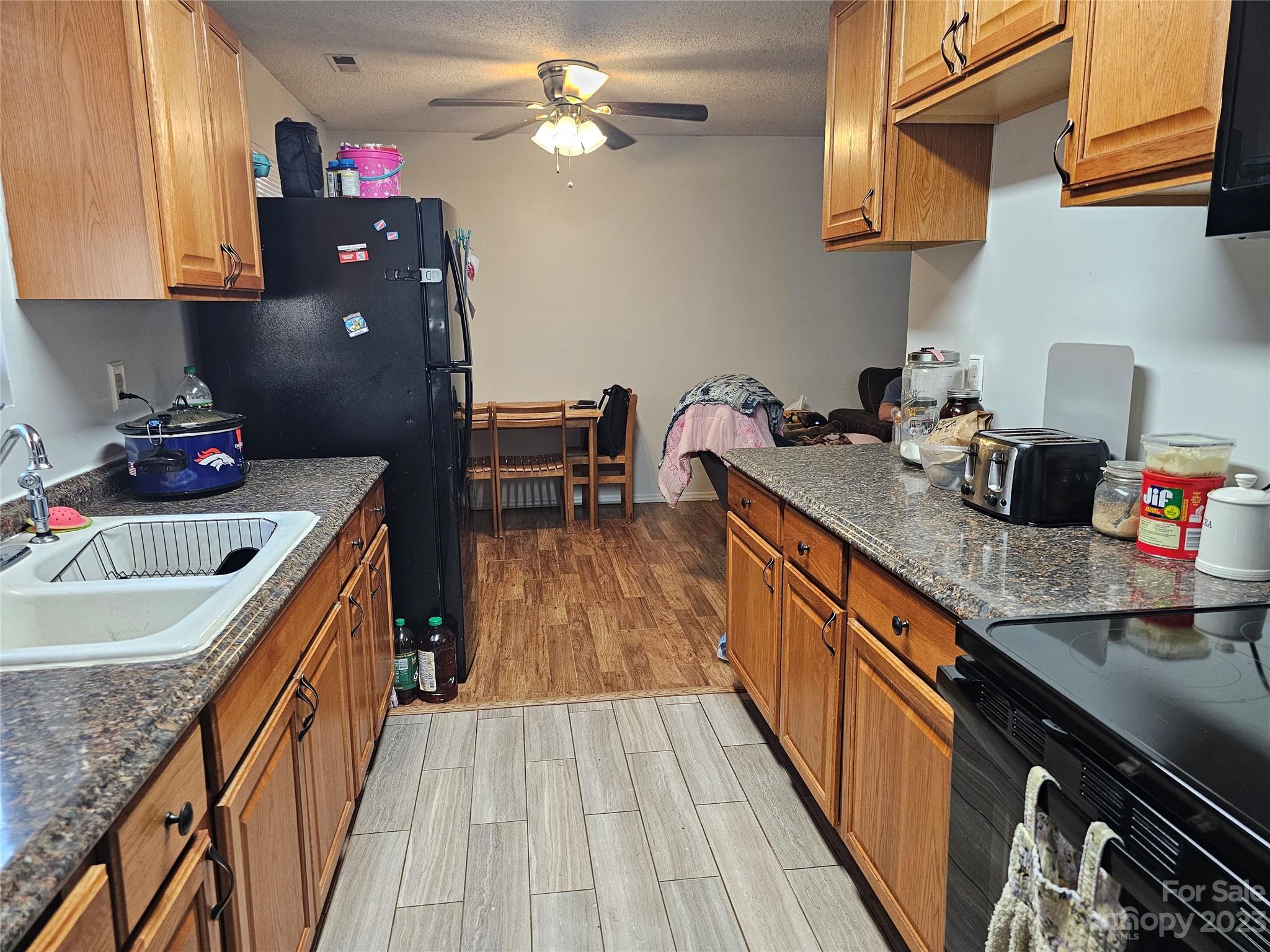 5361 Crawford Road Fort Lawn, SC 29714 - Photo 3 of 15 a kitchen with granite countertop a sink stove and cabinets