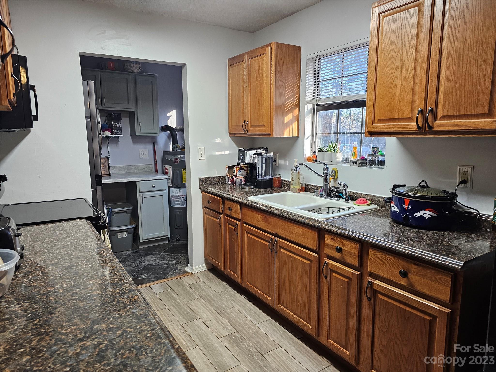5361 Crawford Road Fort Lawn, SC 29714 - Photo 4 of 15 a kitchen with stainless steel appliances granite countertop wooden cabinets a sink and dishwasher