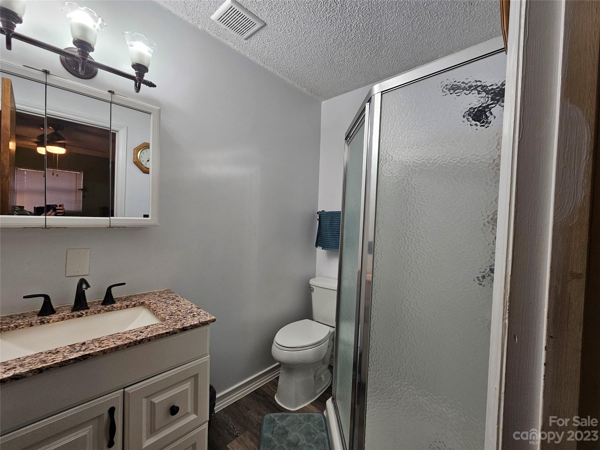 5361 Crawford Road Fort Lawn, SC 29714 - Photo 9 of 15 a bathroom with a granite countertop sink toilet and shower