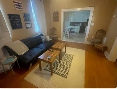 a bedroom with two beds and painting on the wall