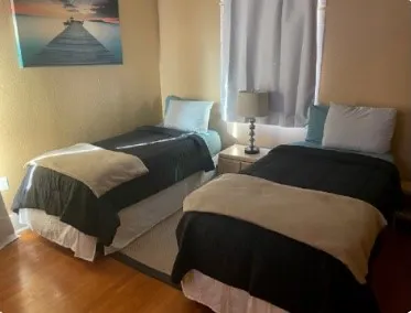 a bedroom with double bed and a window