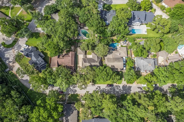 an aerial view of a house with a yard and garden