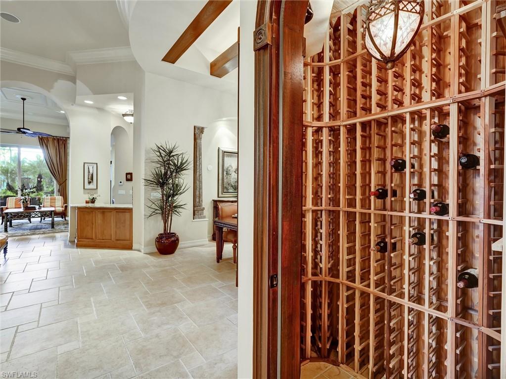 9113 Terrabella Court Naples, FL 34109 - Photo 11 of 47 a view of a hallway with dining area and chandelier