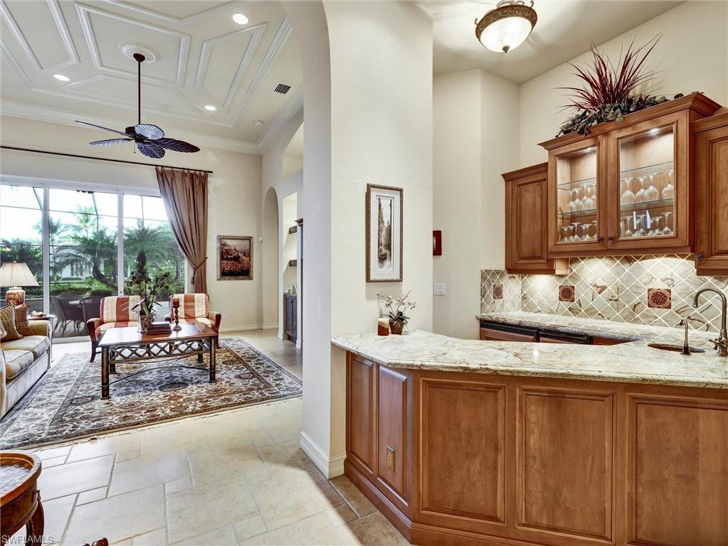 9113 Terrabella Court Naples, FL 34109 - Photo 15 of 47 a living room with granite countertop furniture and a large window
