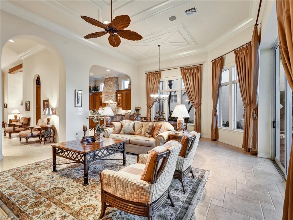 9113 Terrabella Court Naples, FL 34109 - Photo 18 of 47 a living room with furniture and a large window