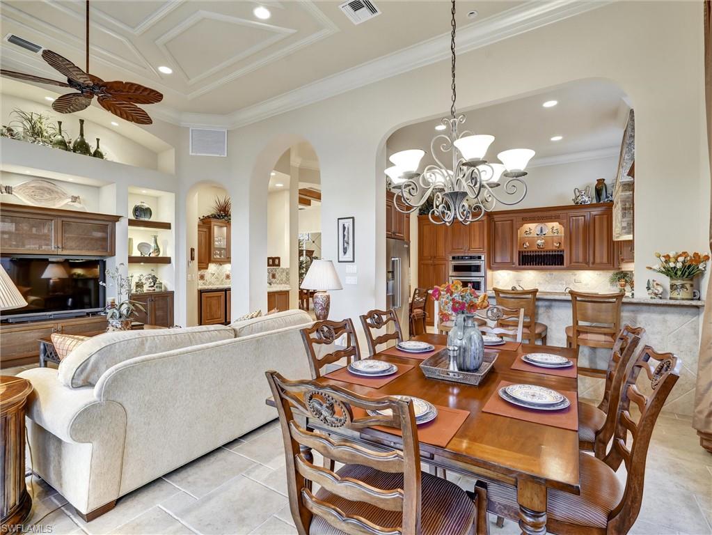 9113 Terrabella Court Naples, FL 34109 - Photo 19 of 47 a view of a dining room with furniture and a chandelier