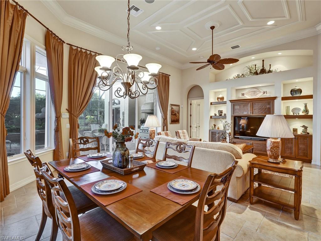 9113 Terrabella Court Naples, FL 34109 - Photo 20 of 47 a view of a dining room with furniture and a chandelier