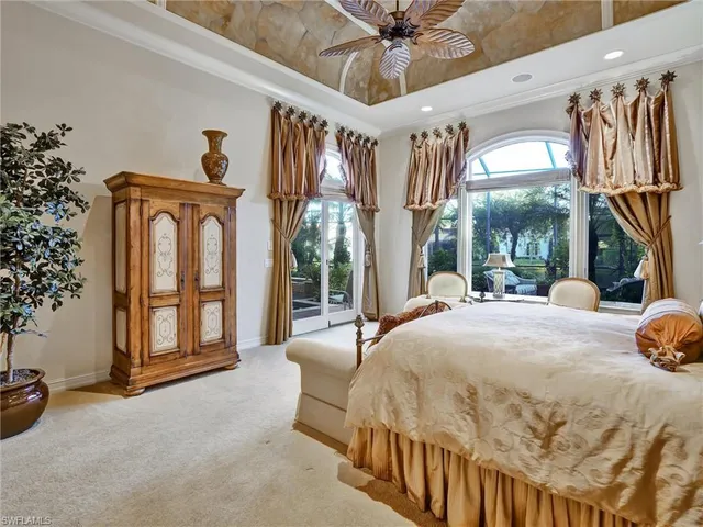 a bedroom with a bed and a large mirror with a flat tv screen