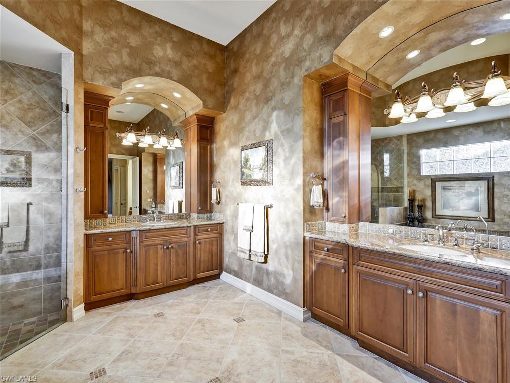 9113 Terrabella Court Naples, FL 34109 - Photo 30 of 47 a large bathroom with a granite countertop double vanity sink and a mirror