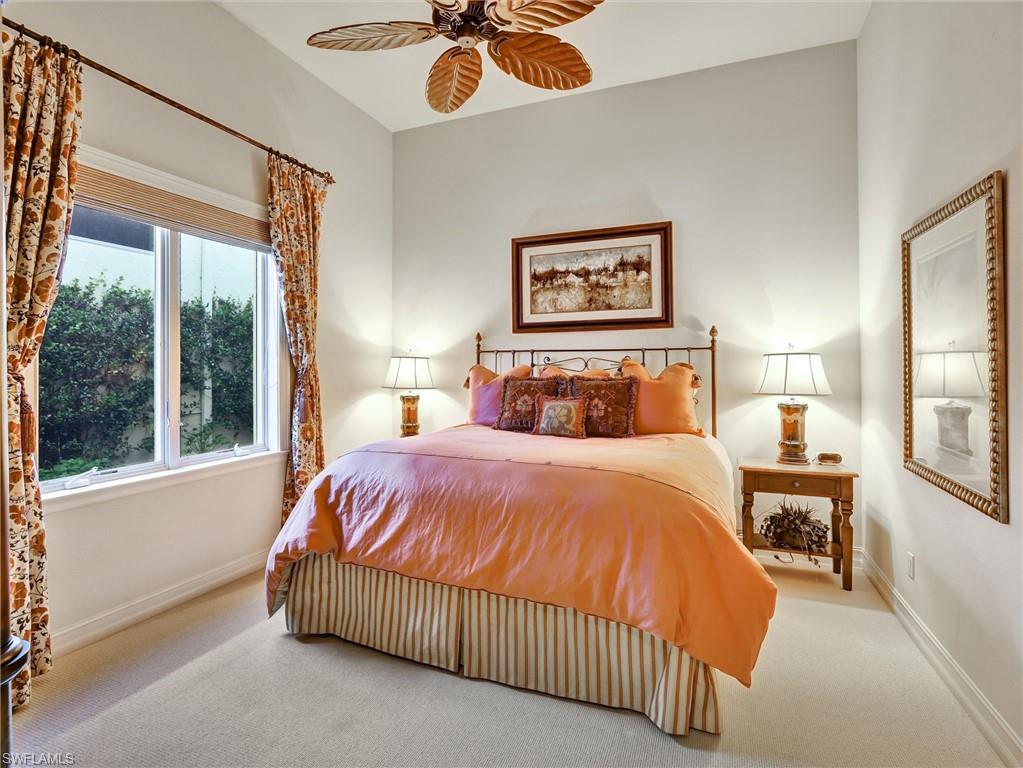 9113 Terrabella Court Naples, FL 34109 - Photo 34 of 47 a bedroom with a bed painting on wall and a large window