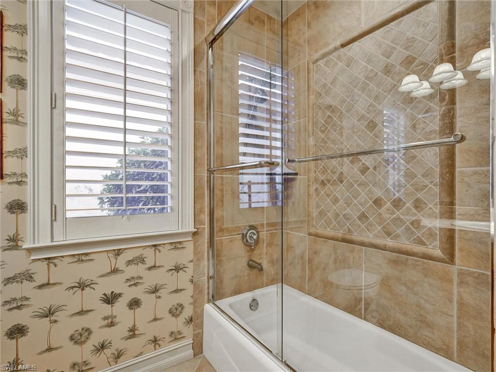 9113 Terrabella Court Naples, FL 34109 - Photo 36 of 47 a bathroom with a bathtub and shower