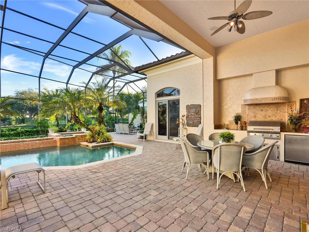 9113 Terrabella Court Naples, FL 34109 - Photo 39 of 47 a view of a swimming pool with a patio