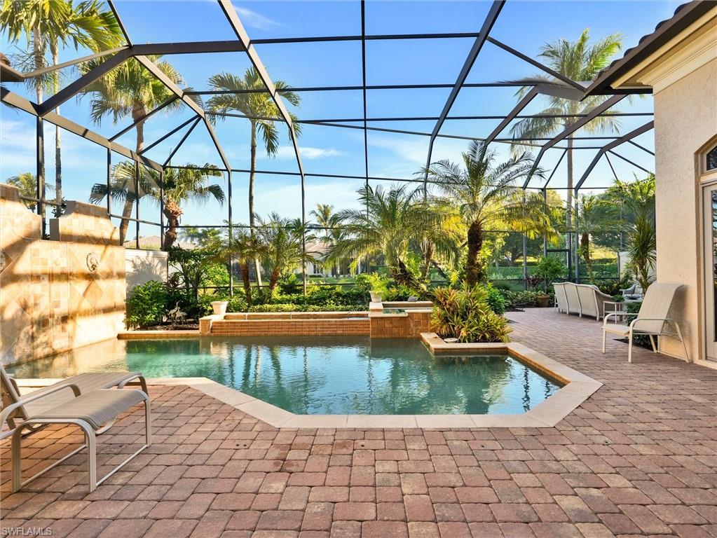 9113 Terrabella Court Naples, FL 34109 - Photo 40 of 47 a view of a swimming pool with a patio