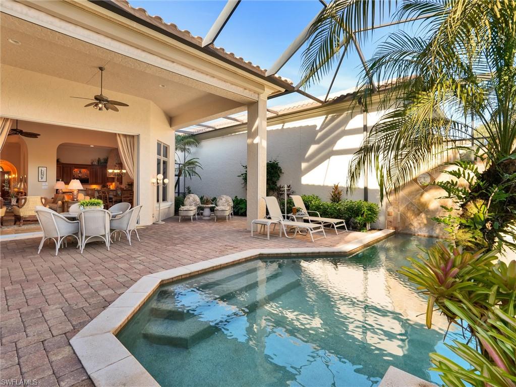 9113 Terrabella Court Naples, FL 34109 - Photo 42 of 47 a view of a swimming pool with a patio