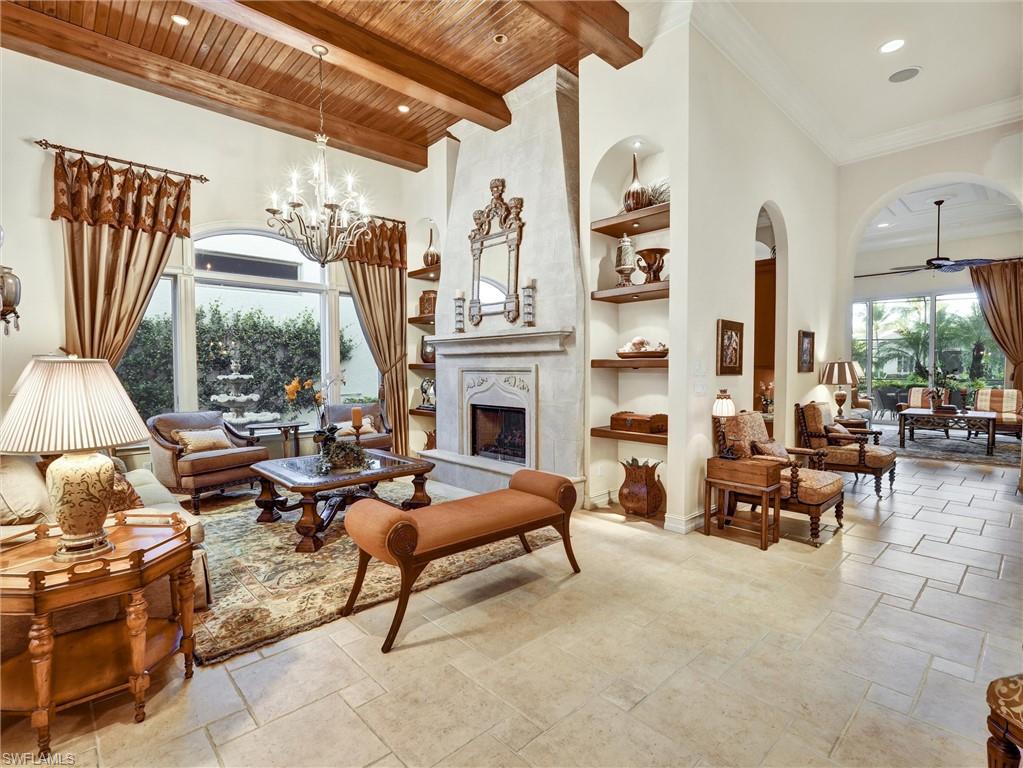 9113 Terrabella Court Naples, FL 34109 - Photo 9 of 47 a living room with furniture fireplace and a large window