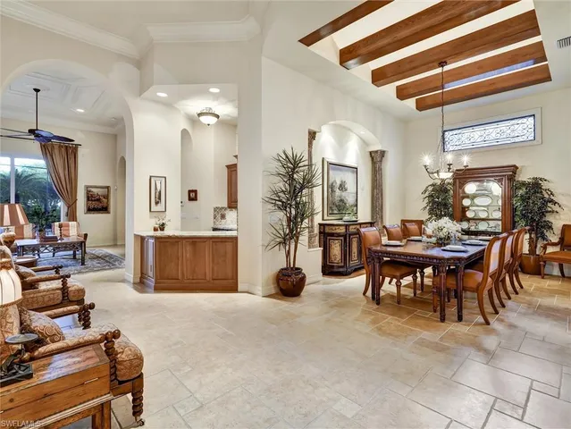 a living room filled with furniture and a chandelier