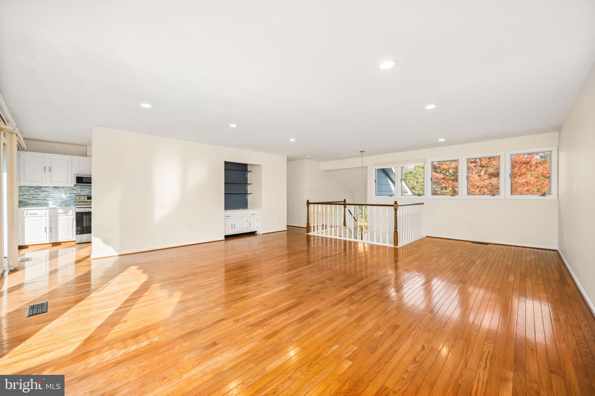 24700 Deepwater Point Drive, Unit 1 St. Michaels, MD 21663 - Photo 12 of 47 a view of an empty room with wooden floor and a window