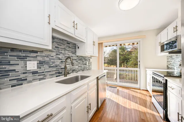 a kitchen with a sink and large wooden cabinets