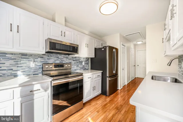 a kitchen with a sink stove and refrigerator