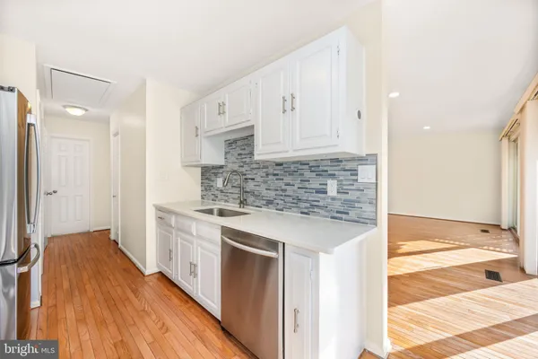 a kitchen with stainless steel appliances granite countertop a stove and a refrigerator