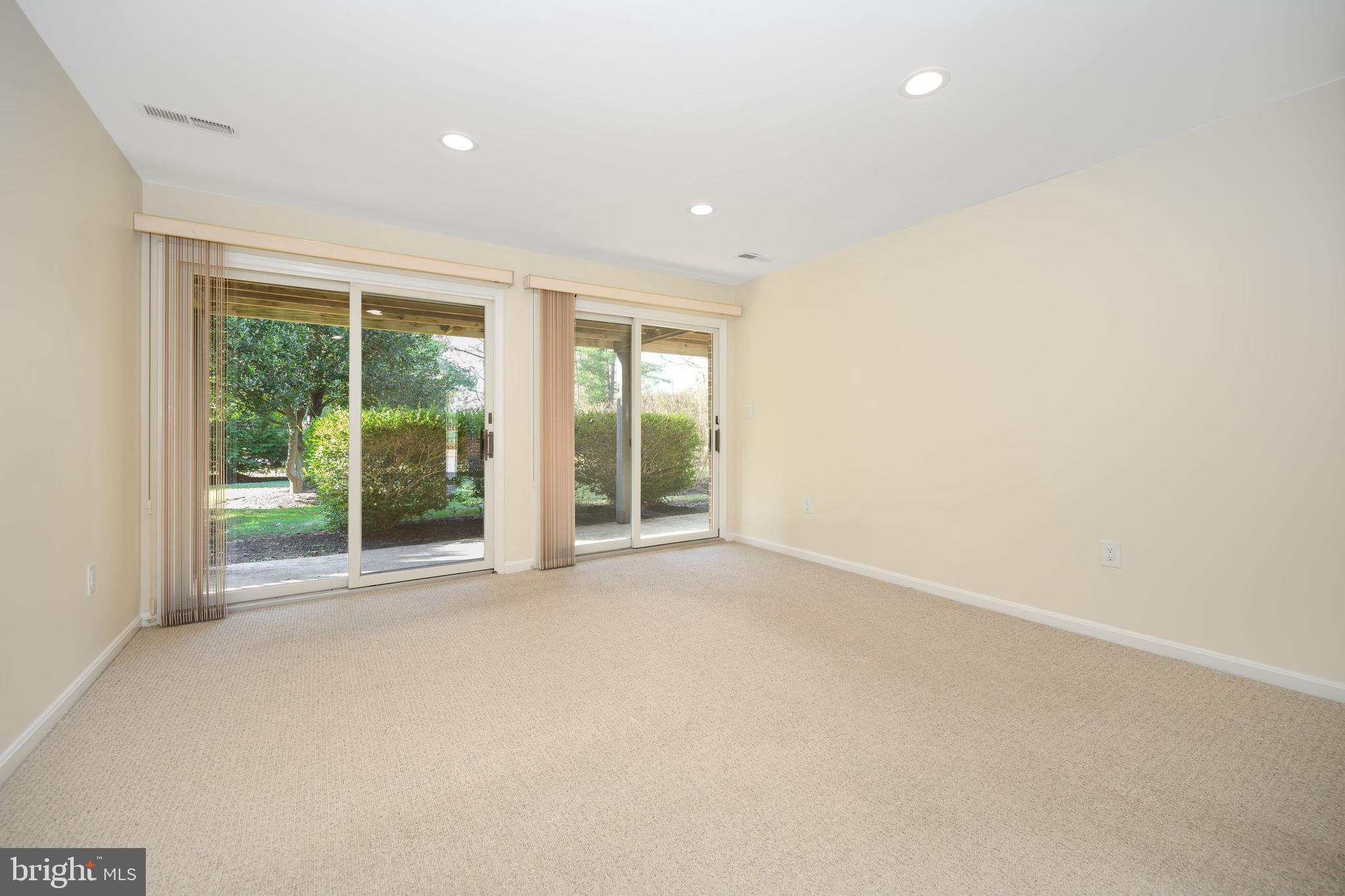 24700 Deepwater Point Drive, Unit 1 St. Michaels, MD 21663 - Photo 21 of 47 a view of an empty room with wooden floor and a window