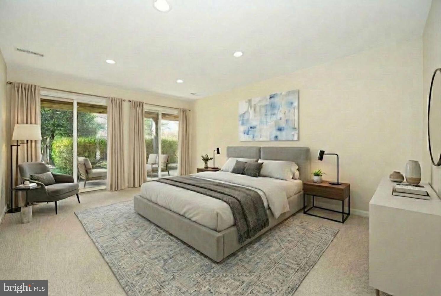 24700 Deepwater Point Drive, Unit 1 St. Michaels, MD 21663 - Photo 22 of 47 a spacious bedroom with a large bed and a couch