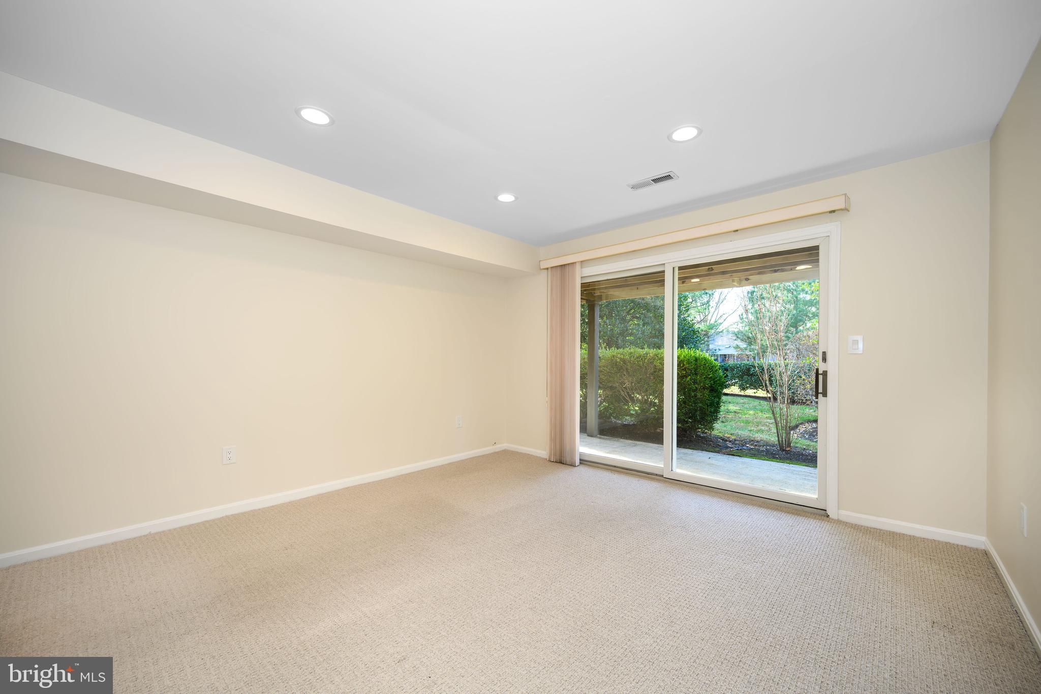 24700 Deepwater Point Drive, Unit 1 St. Michaels, MD 21663 - Photo 23 of 47 a view of an empty room with wooden floor and a window