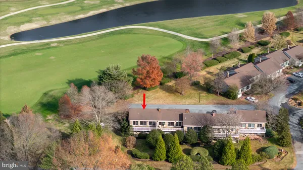 an aerial view of a house with a yard and lake view